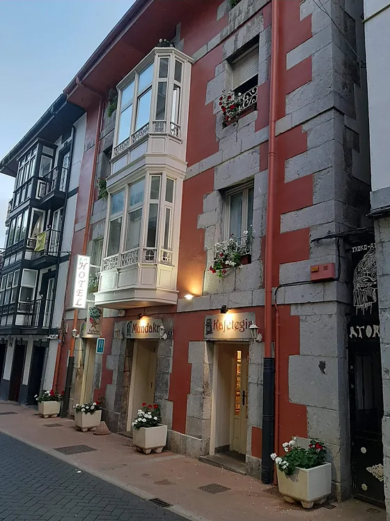 La fachada del Eco-Hotel Mundaka, con sus balcones de madera y el rótulo vertical.